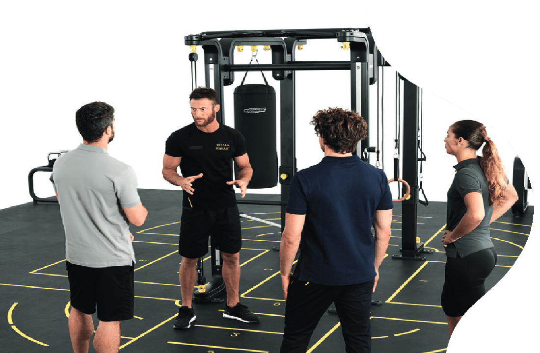 A group of people in the gym talking to each other.