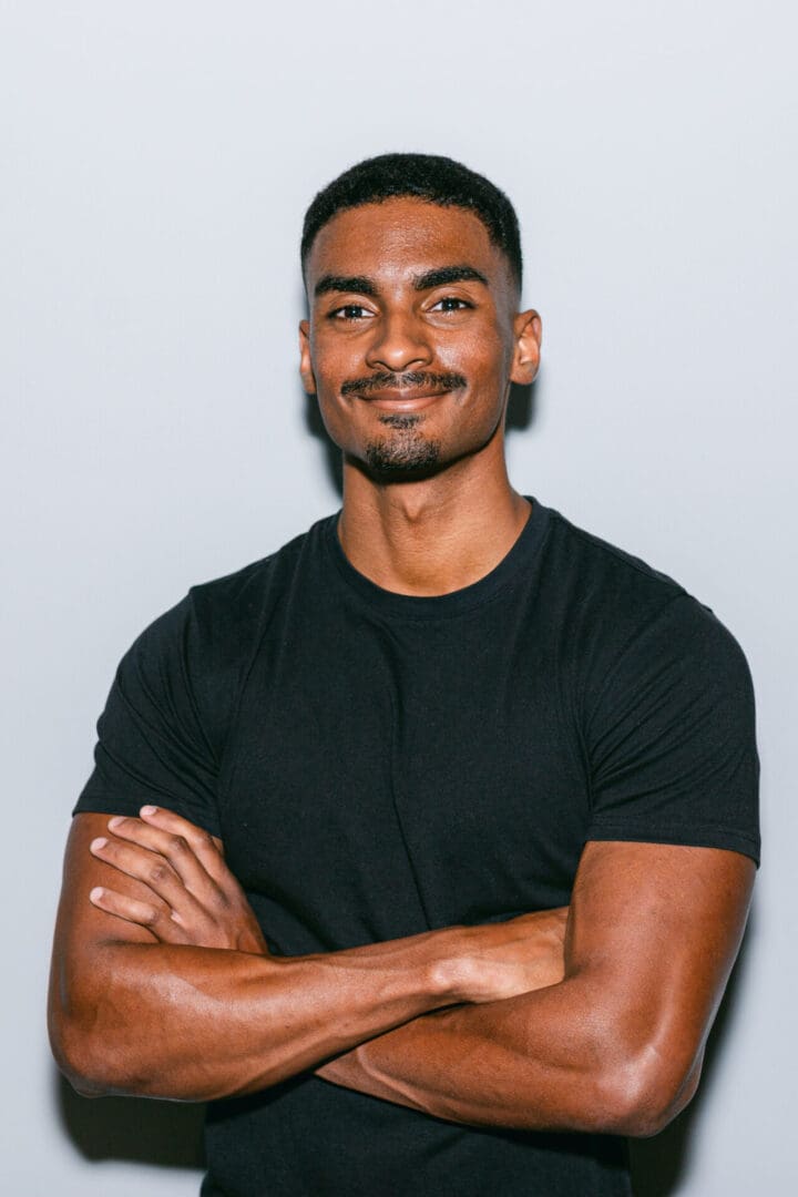 Man in black shirt with arms crossed.