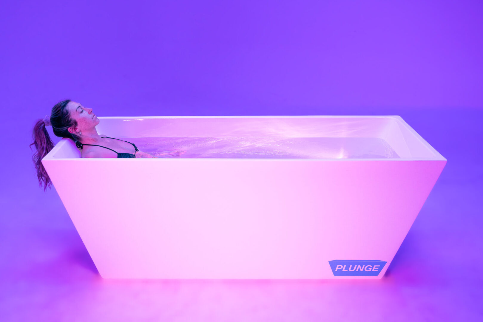 Woman relaxing in a plunge pool.